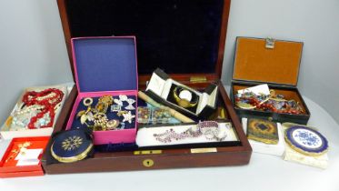 A collection of costume jewellery including brooches, necklaces and compacts with an Elkington