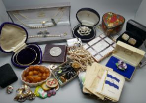 A collection of costume jewellery, badges, etc.