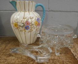 A large early 20th Century jug with floral detail, a glass bowl and two pairs of salad servers