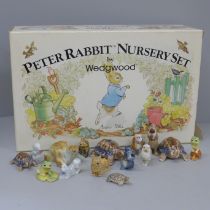 A collection of Wade Whimsies and other Wade figures and a Wedgwood Peter Rabbit nursery set, boxed,