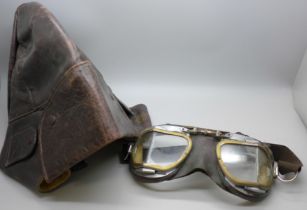 A leather motorcycle riding cap and a pair of goggles