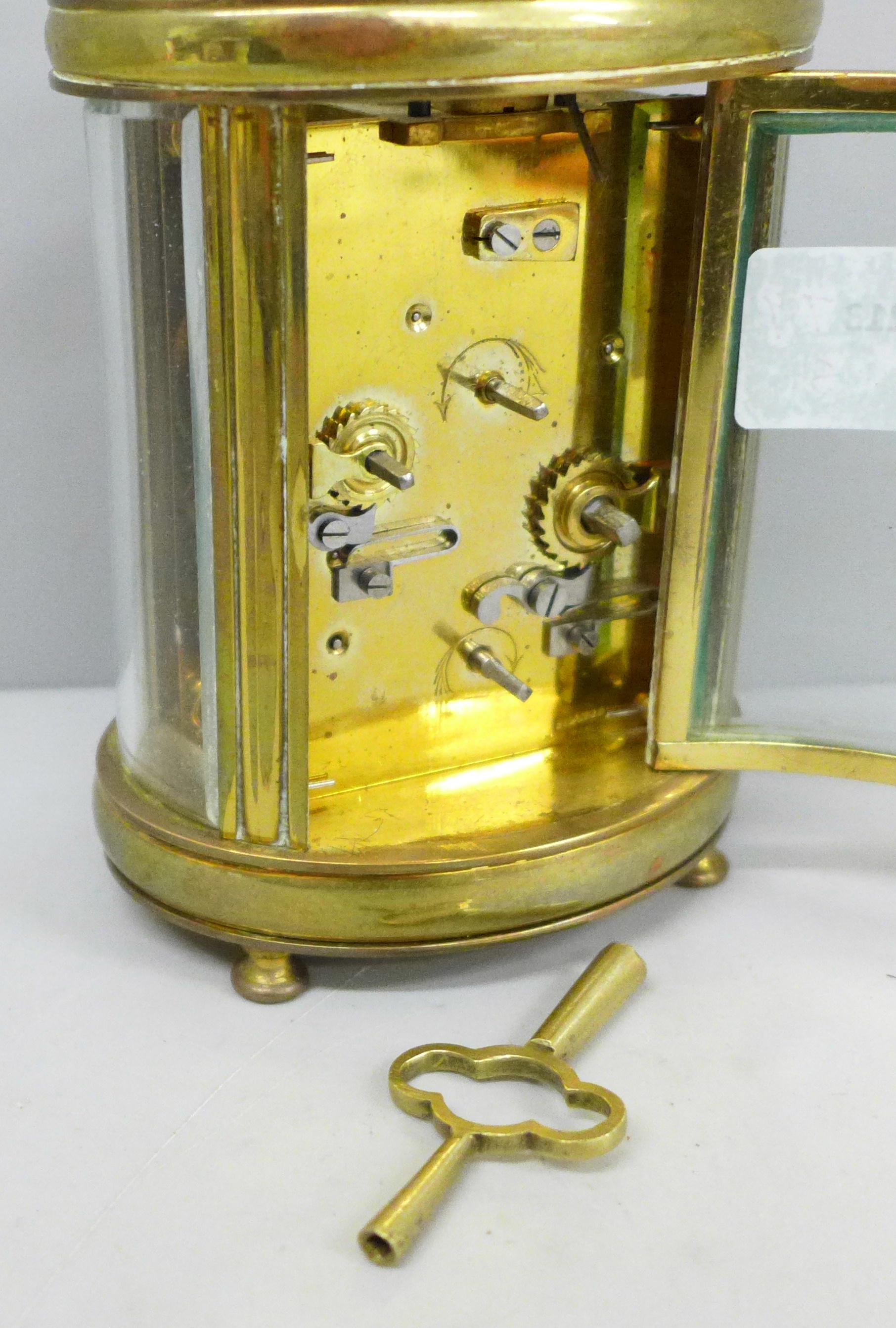 A French 19th Century gilt brass and glass oval cased carriage clock, with alarm - Image 3 of 5