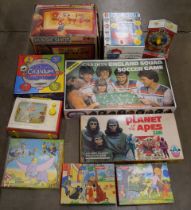 A collection of toys and games including puzzles, Planet of the Apes game, Magicshot, etc. **