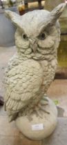 A concrete garden figure of an owl