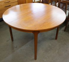 A McIntosh circular teak extending dining table