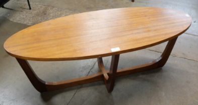 An oval teak coffee table
