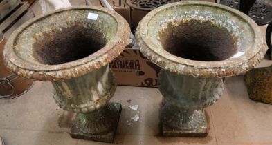 A pair of Victorian cast iron campana shaped garden urns