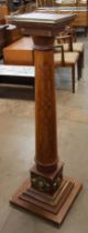 A French inlaid walnut and parcel gilt column shaped torchere