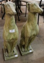 A pair of concrete garden figures of seated hounds