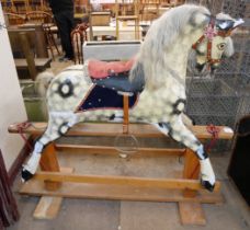 A vintage dapple grey rocking horse