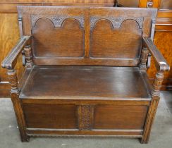 A 17th Century style carved oak monk's bench