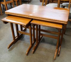 A Jentique teak fold-over nest of tables