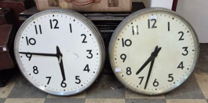 A pair of vintage industrial factory clocks