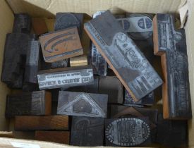 A box of vintage letterpress printing blocks, company logos etc.