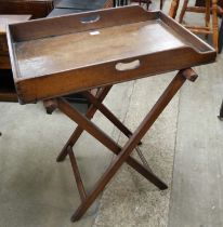 A Victorian mahogany butlers tray on folding stand