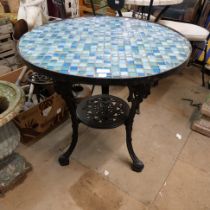 A cast iron based tiled top pub table