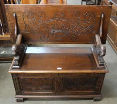 A 17th Century style carved oak monk's bench