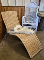 A painted wicker chair, a wicker lounger and faux fur rug