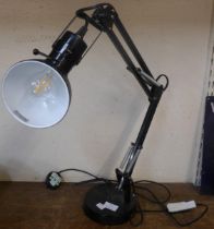 A black metal anglepoise desk lamp