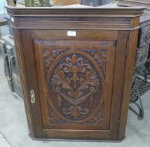 A Victorian carved walnut wall hanging corner cabinet