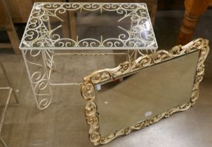 A wrought iron and glass topped table and a mirror