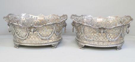 A pair of Victorian pierced silver baskets with lion head ring handles and ram and swags details,