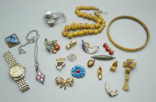 A gold colour bangle, a lady's Rotary watch and a collection of brooches, charms, etc.