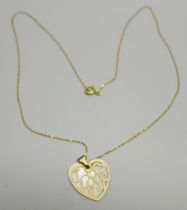 A 9ct gold mounted pendant on a fine 9ct gold chain, chain 38cm