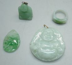 An ice green jade carved laughing Buddha pendant, a jade ring, a small carved jade ram pendant and a