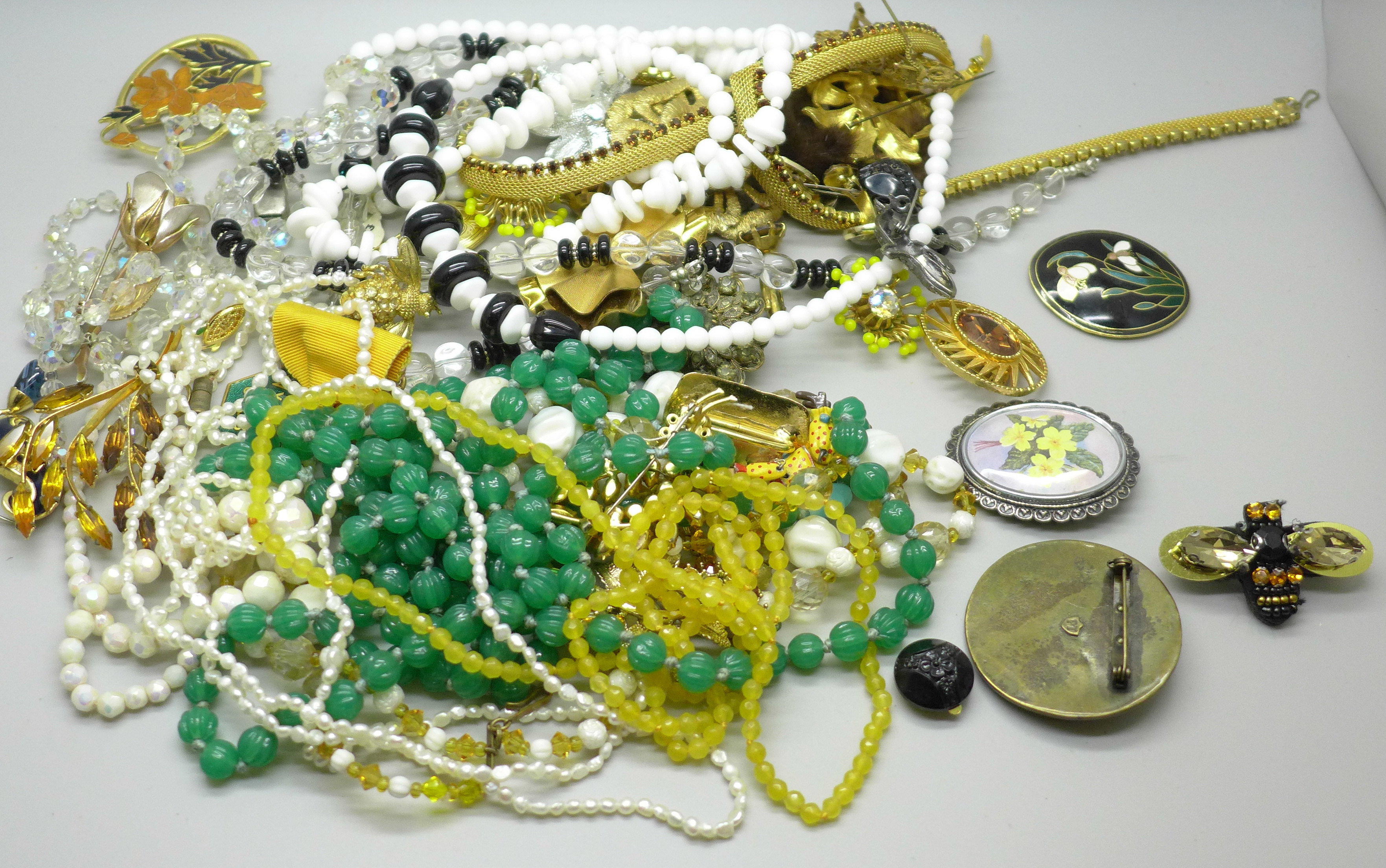A collection of costume jewellery including brooches, bead necklaces, seed pearls and earrings