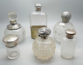 Four silver topped scent bottles, a silver mounted scent bottle and a silver topped flask