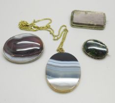 A gilt metal mounted agate pendant, a silver and agate brooch by Malcolm Gray, a moss agate