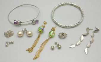 A silver bangle, an unmarked white metal bangle with thistle detail, and seven pairs of silver and