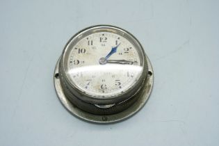 An 8-day car clock, the dial marked '8 Tage', diameter of glass 5cm