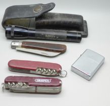 A Zippo lighter, a Swiss Army knife, two other knives and a British Transport Police Mini-Maglite