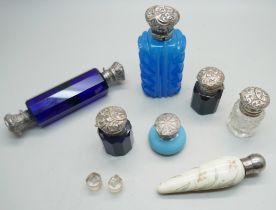 Seven scent bottles, four with Victorian silver tops, a/f