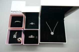 Pandora jewellery including three rings, a necklace and two charms