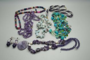 A turquoise seven strand necklace with silver clasp, two amethyst necklaces, one with earrings, a