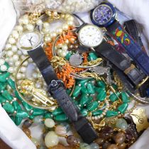 A case of costume jewellery including a coral necklace, wristwatches, etc.