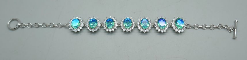 A silver bracelet set with blue/green and white stone clusters, 19.5cm, 17g