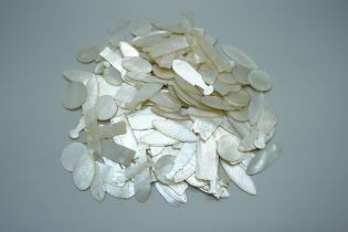 A large collection of mother of pearl game tokens including fish shaped, over 150 in total