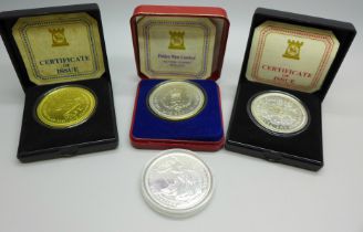 A 2012 Britannia One Ounce Fine Silver 2 Pounds coin and three Pobjoy Mint Isle of Man commemorative