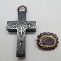 A jet cross pendant with detail and a Georgian gold toned garnet, seed pearl and amethyst brooch