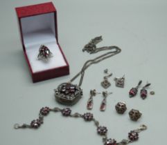 A silver, garnet and marcasite ring, four pairs of garnet and marcasite earrings (two pairs with