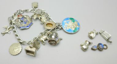 A silver charm bracelet with silver and white metal charms, 50g