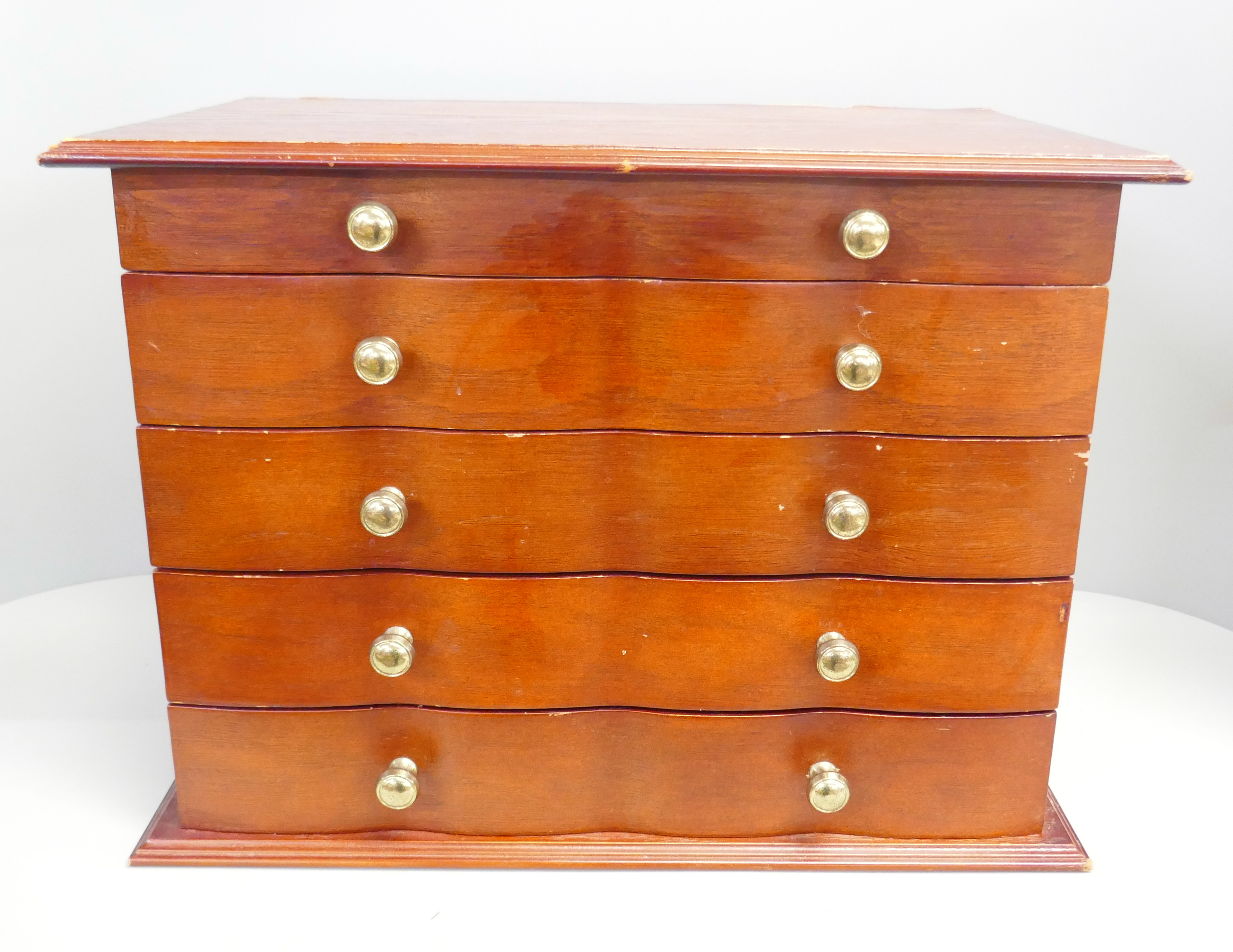 A collection of costume jewellery and three lady's wristwatches, in a jewellery cabinet