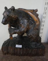 A carved figure of a bear 31cm high