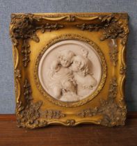A gilt framed faux marble plaque