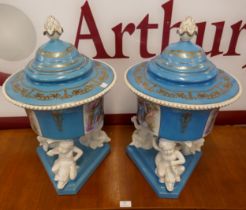 A pair of porcelain lidded pots on stands