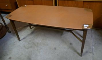 A teak and faux leather topped coffee table